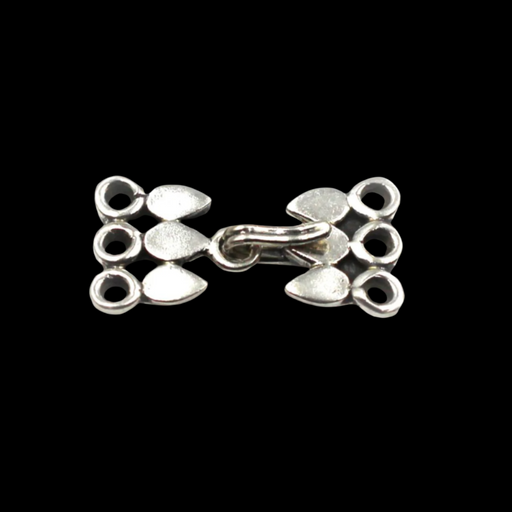 Silver three-strand clasp on a black background