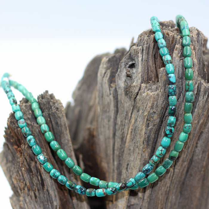 Turq 113   Turquoise barrel shaped bead strand.