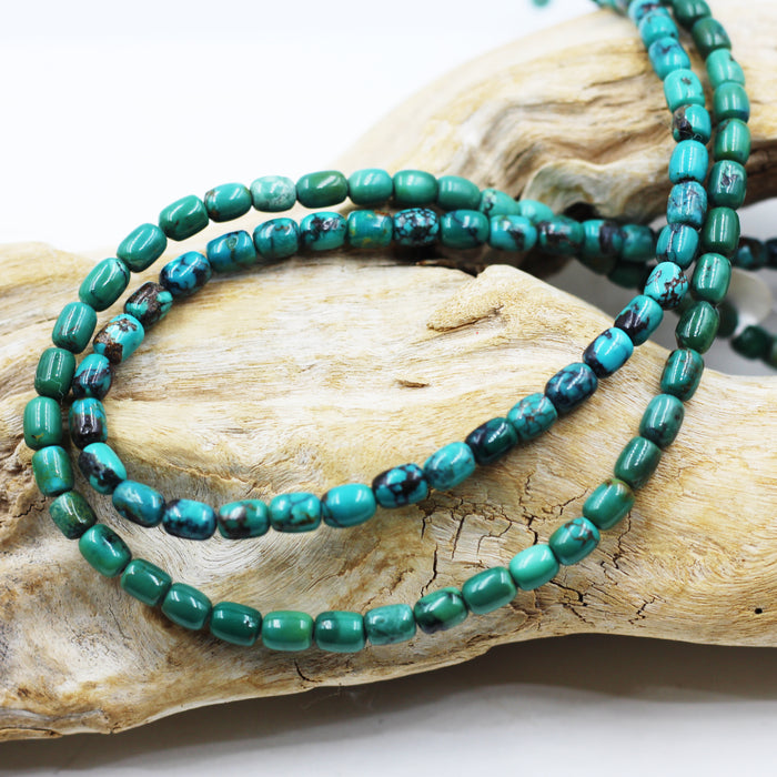 Turq 113   Turquoise barrel shaped bead strand.