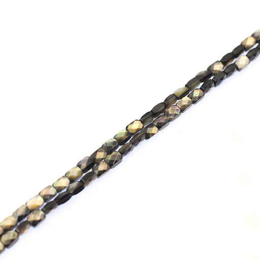 A strand of faceted black lip shell beads.