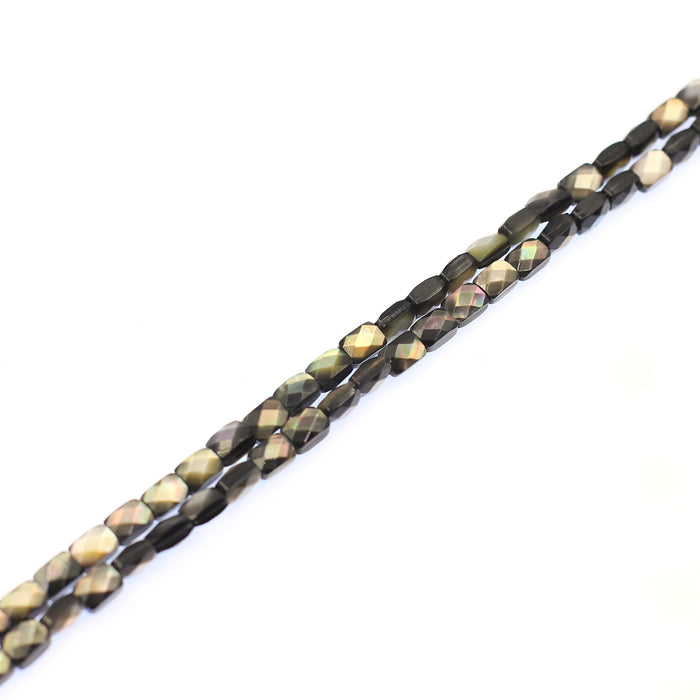 A strand of faceted black lip shell beads.