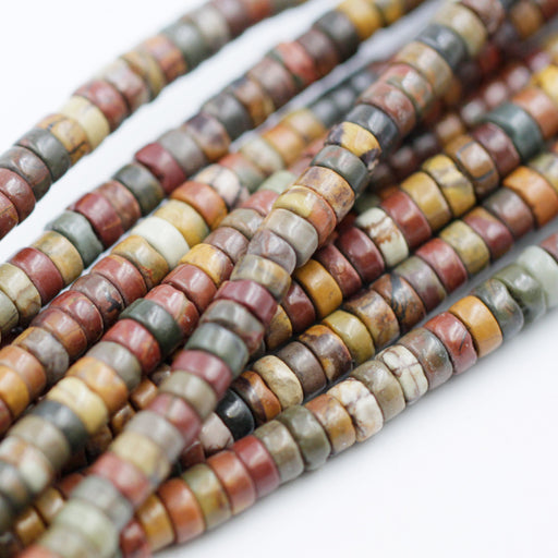 A strand of red creek jasper beads with varying shades and patterns.