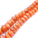 A series of orange-colored sunstone beads of varying sizes strung together.